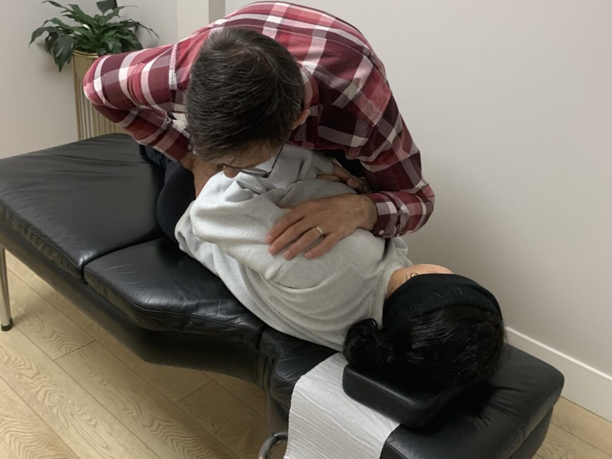 Chiropractor adjusting the spinal alignment of a patient.