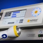 SoftWave Tissue Regenerative Therapy device with focused acoustic wave applicator, used in non-surgical treatment to support tissue healing and pain reduction.