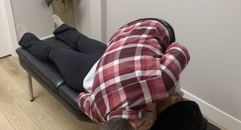 Dr. Nik Dukovac performing a chiropractic spinal adjustment at Fairway Chiropractic Centre in Kitchener