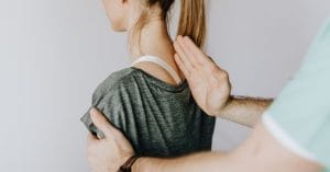 Chiropractor assessing a patient spine for spinal decompression in Kitchener
