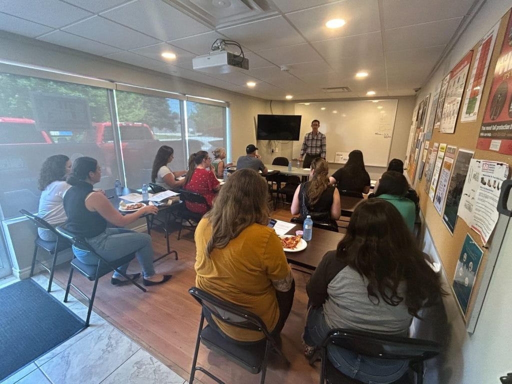 Dr. Nik Dukovac presenting a back injury prevention talk to a seated group of employees